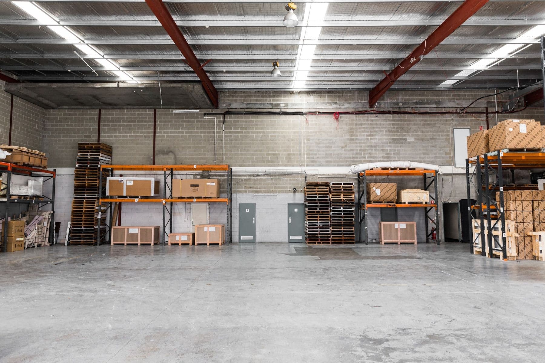 Crated and cartoned stock held on racking inside an Ateam Logistics warehouse.